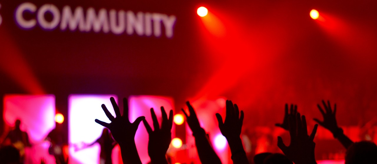 Community hands up at a concert